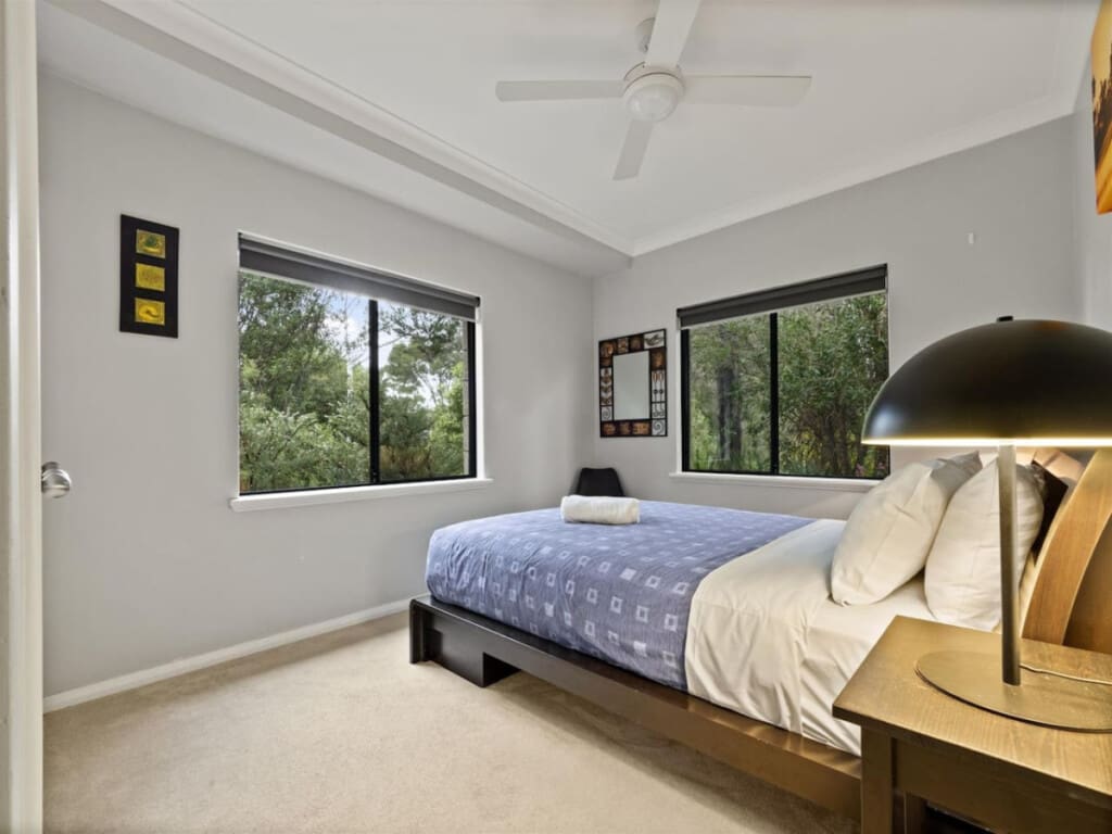 Bedroom 2 - 1 Queen bed, Ceiling fan, and a Garden view