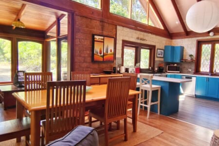 Open plan dining and kitchen with forest views