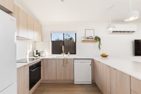 Gourmet Kitchen including induction cooktop, oven, filtered drinking water & dishwasher